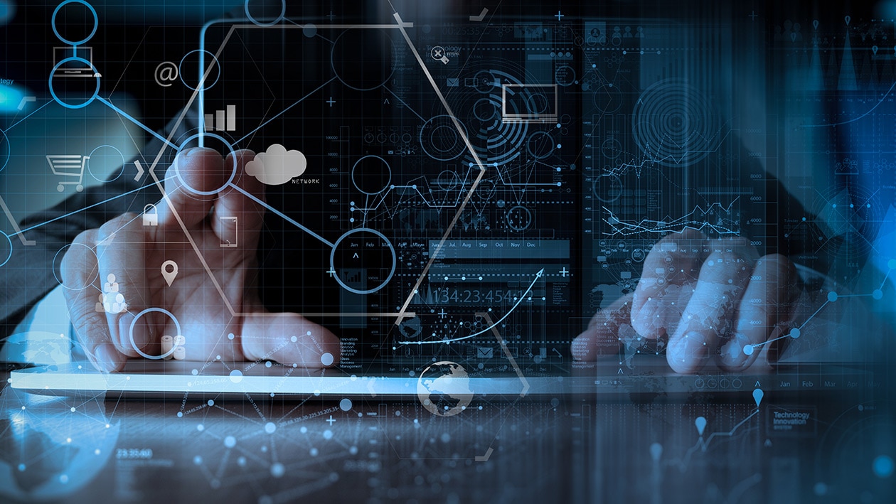 Seamless Deployment Image showing businessman hand working with modern laptop computer in modern office with virtual icon diagram