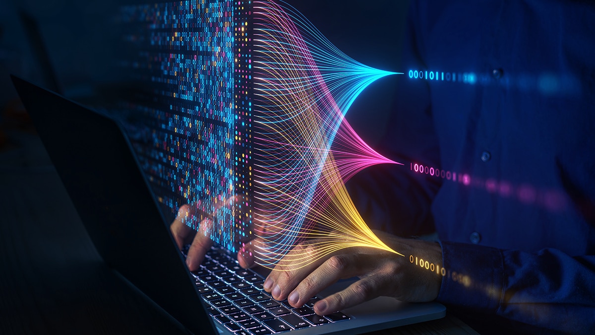 Person coding on laptop