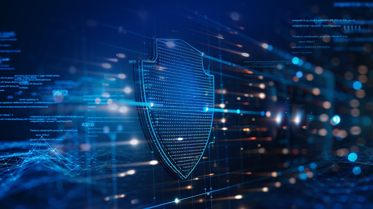 Glowing digital shield icon over blue data streams and code, symbolizing cybersecurity, data protection, and network security.