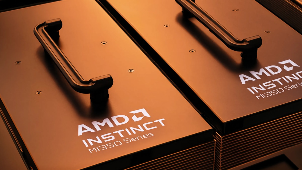 AMD Instinct MI350 Series accelerator modules with integrated handles and illuminated product branding in warm orange lighting.