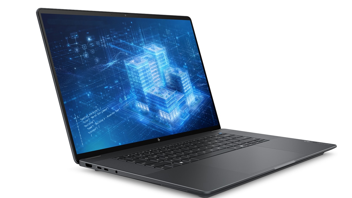 Black HP laptop displays a blue digital building visualization with network graphics and code.
