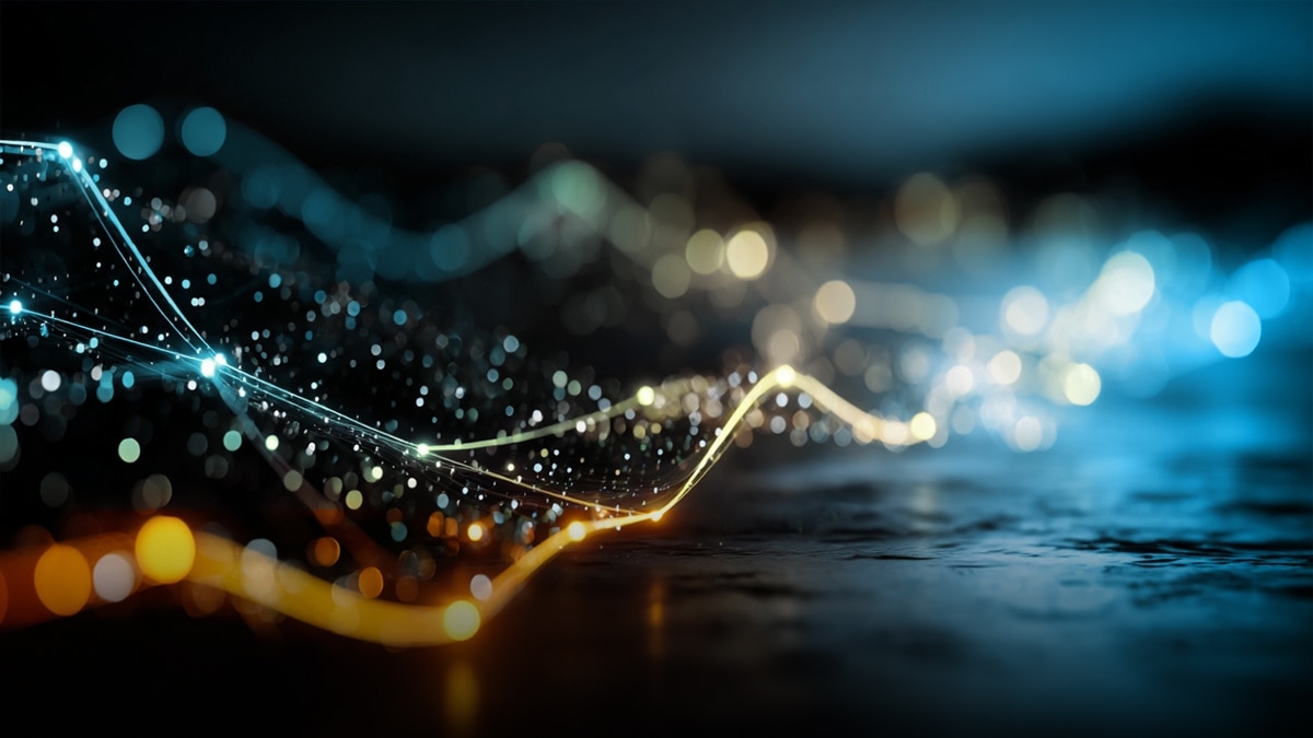 Glowing teal and orange signal wave with sparkling particles across a dark surface