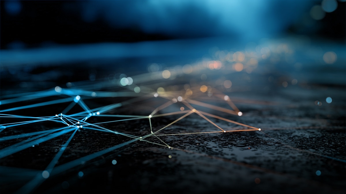 Teal and orange network lines and nodes connected across a dark textured surface, symbolizing data connectivity