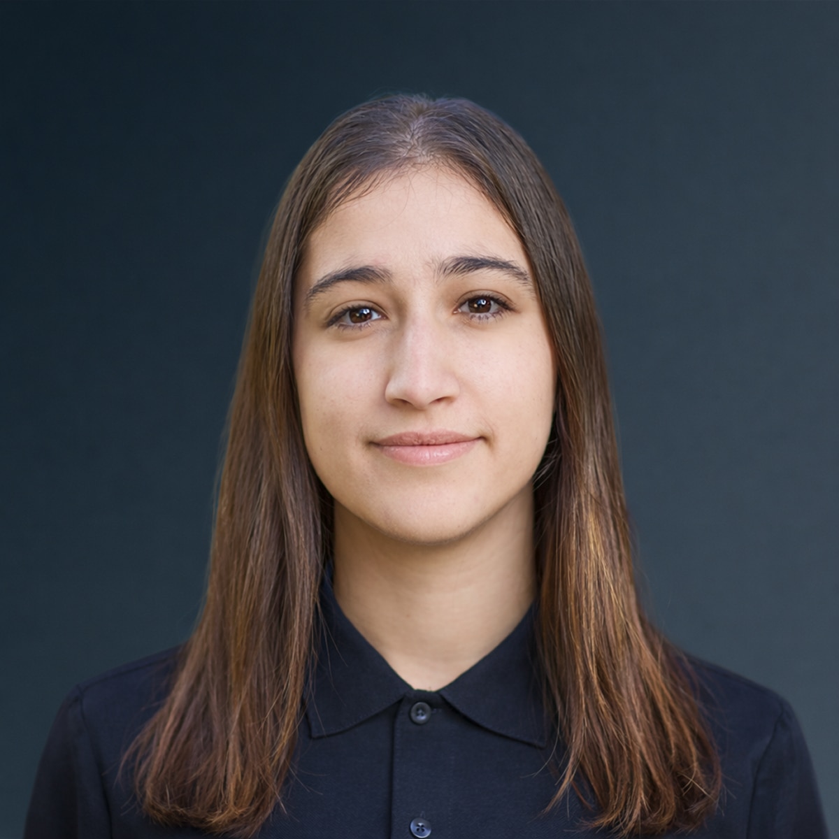 Woman with long brown hair wearing black collared shirt