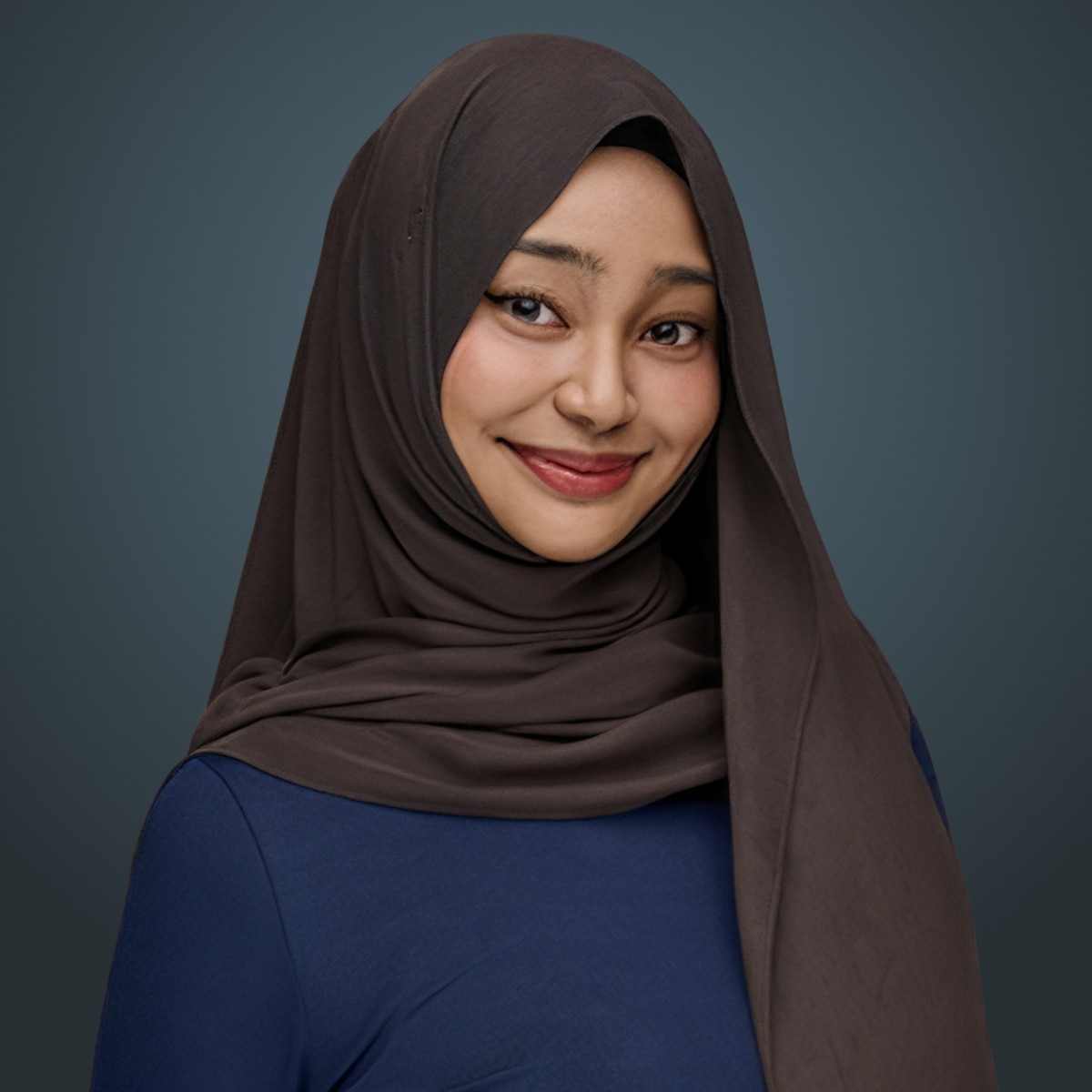 Smiling person wearing a brown hijab and navy blue top against a dark teal background.