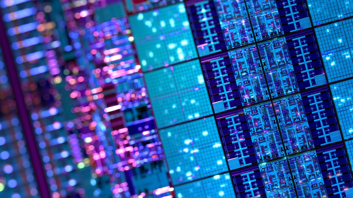 Semiconductor processors move along a production line while technicians in cleanroom suits inspect and assemble components.