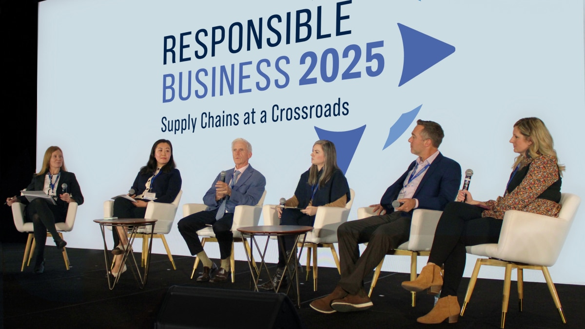 Panel discussion at Responsible Business 2025 with six speakers on stage. Screen reads "Responsible Business 2025: Supply Chains at a Crossroads."