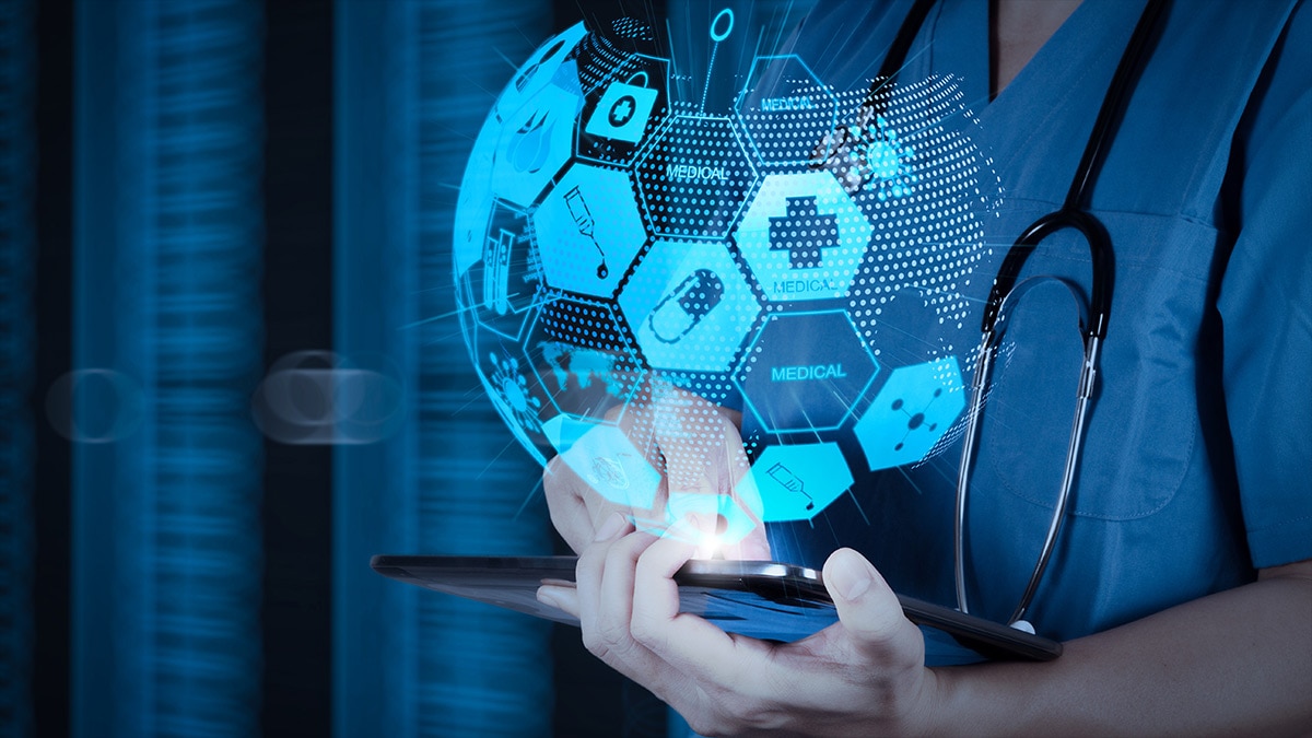 Healthcare professional holding a tablet with a holographic medical interface showing health icons as a globe