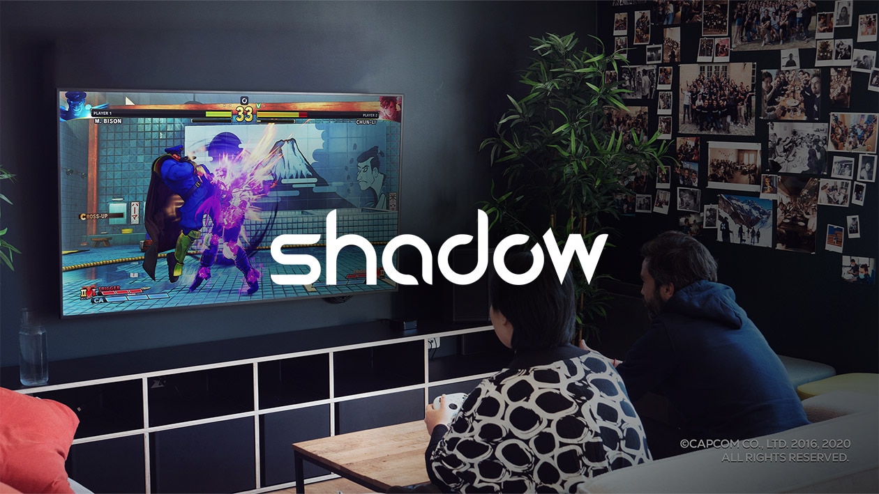 Cloud Services: Shadow Image showing Shadow logo in white color with man and woman playing video game on sofa