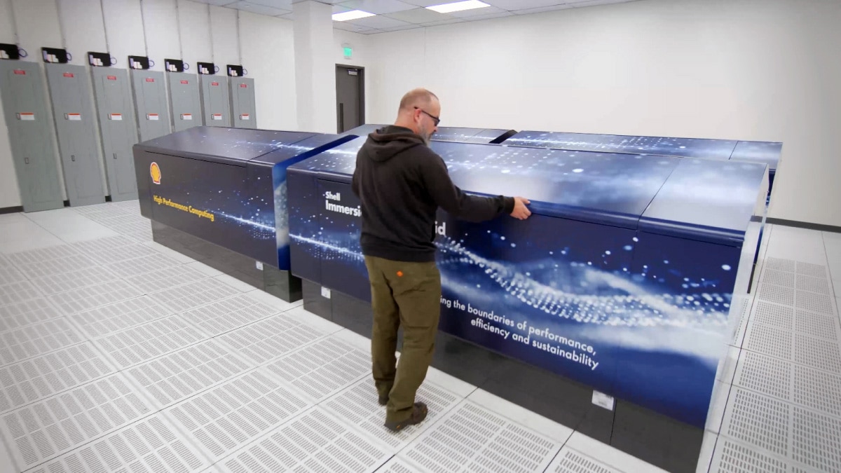 Operator manipulating an immersion cooling tank