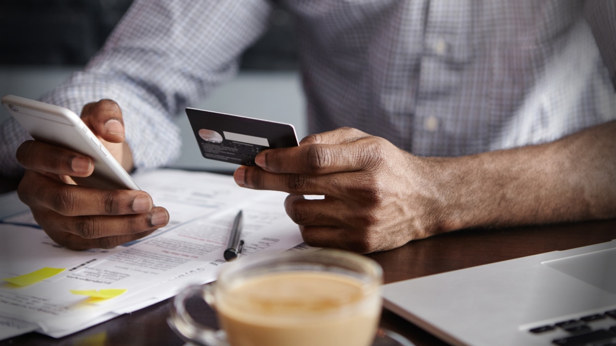 man looking at credit card