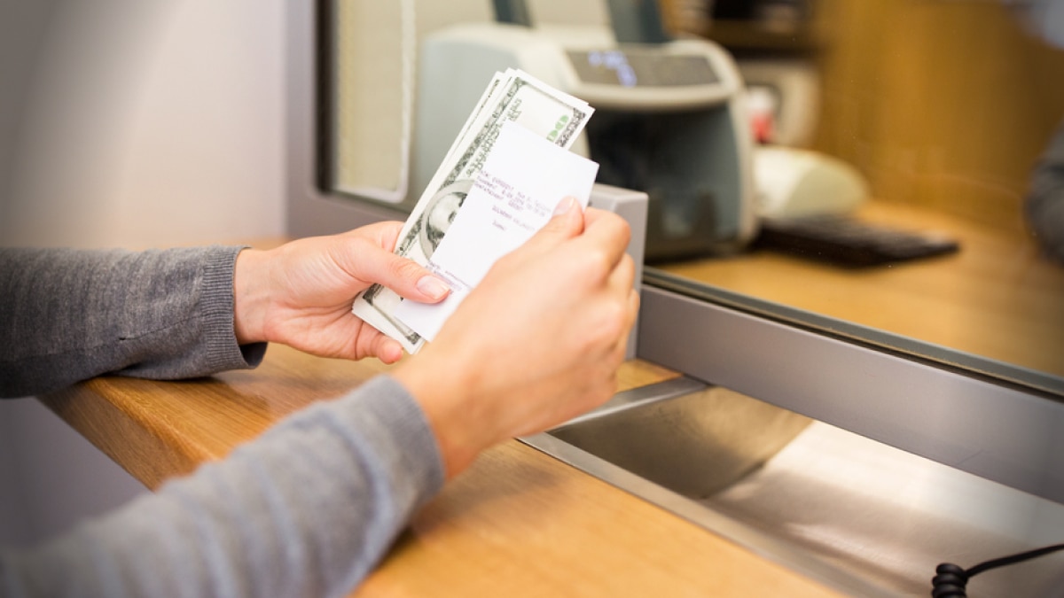 woman holding cash at window