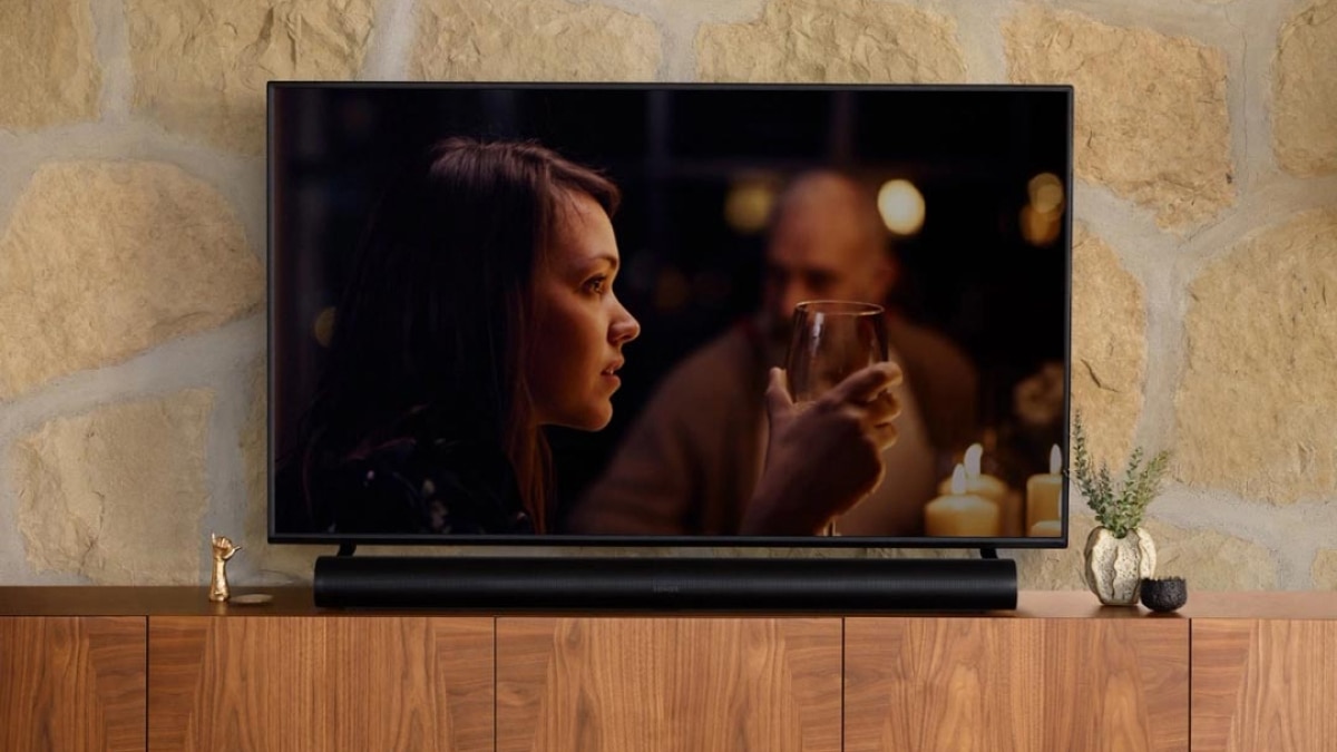 Sonos speaker on table with large TV