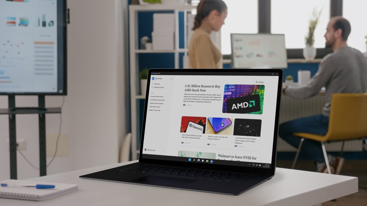 Two developers working at desks with large monitors showing code in a bright, modern office environment.