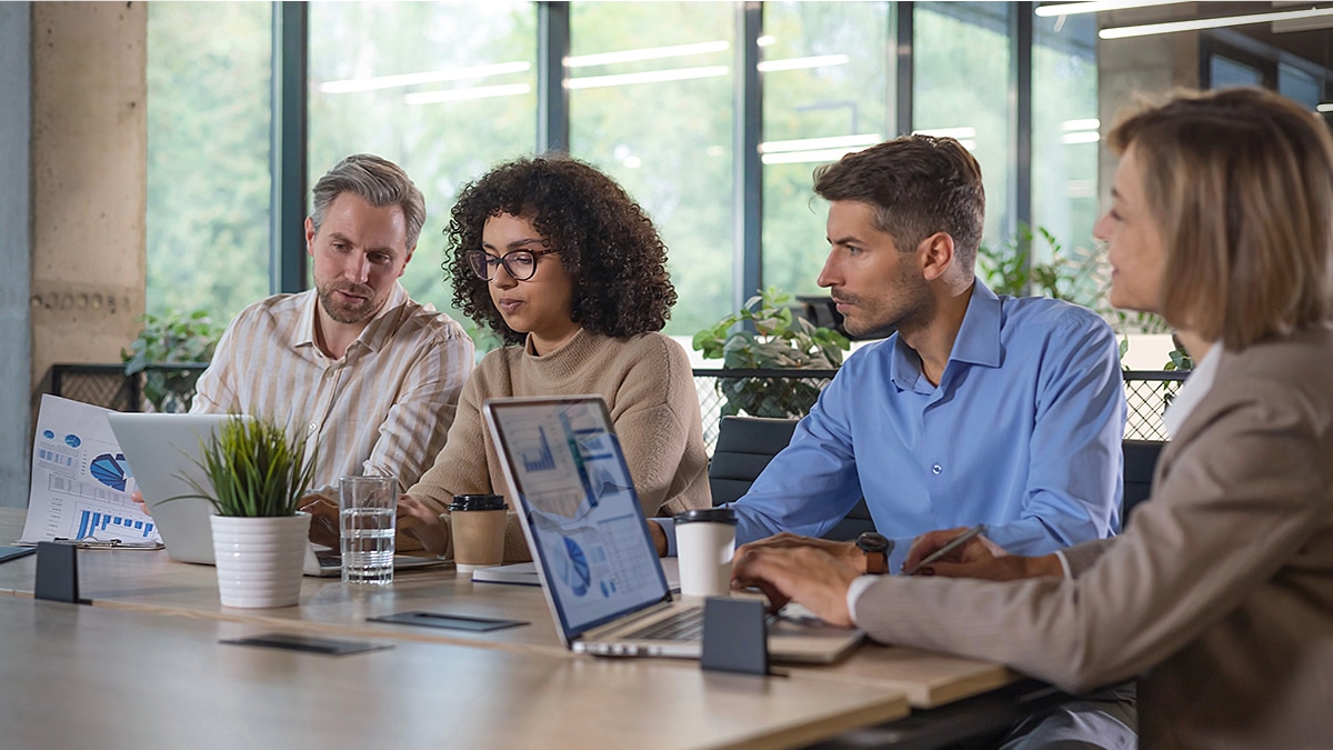 Business team reviewing charts and analytics during a collaborative office meeting.
