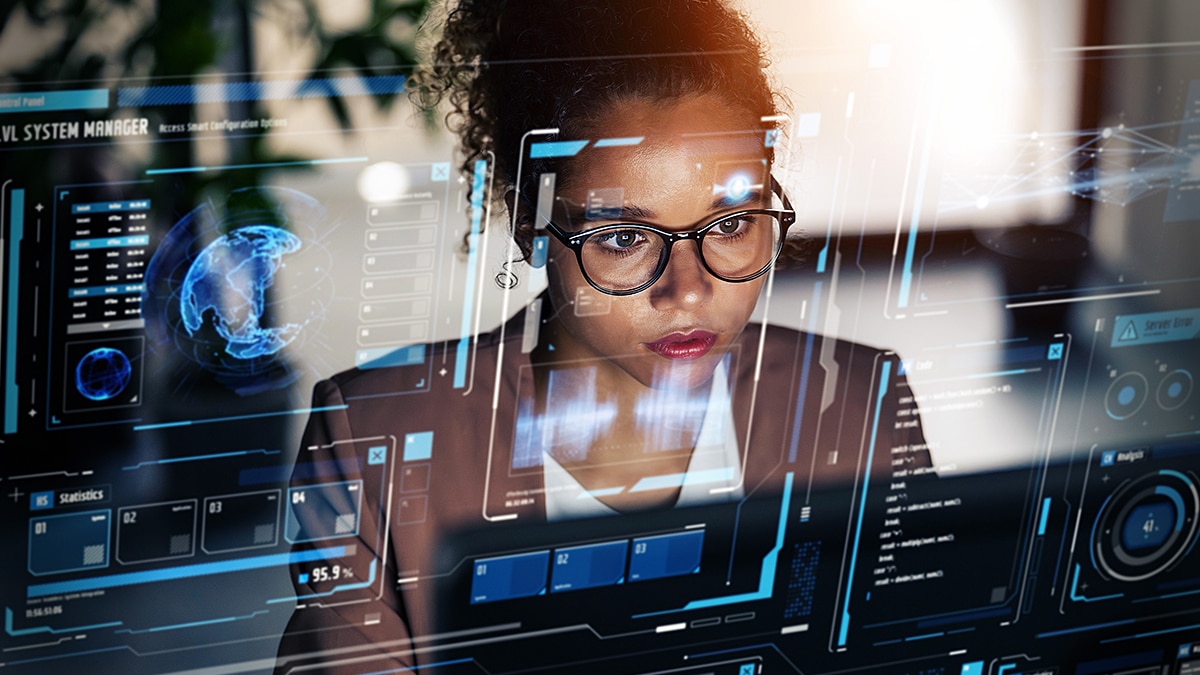 Cybersecurity analyst viewing holographic data dashboards and network monitoring screens.