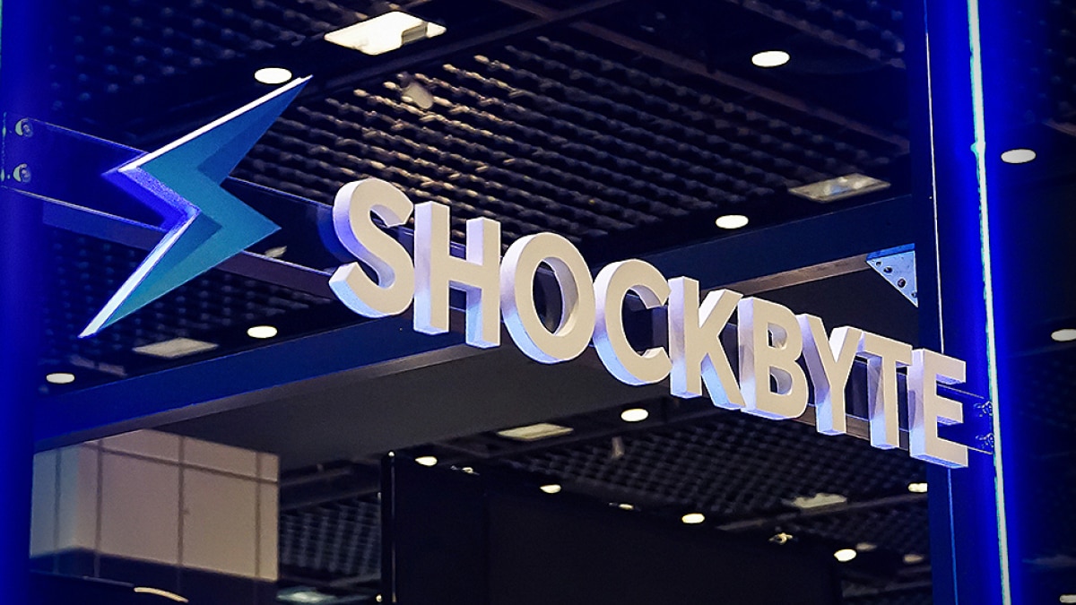 Shockbyte logo and name displayed on illuminated blue trade show booth signage.