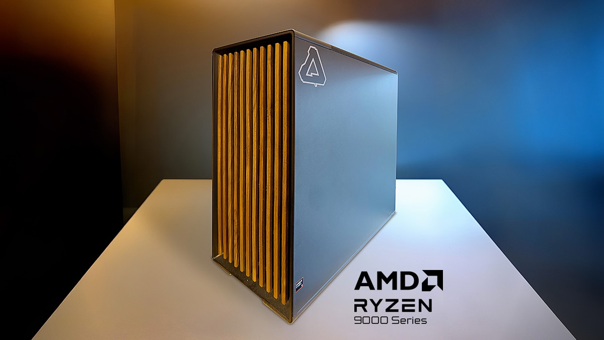 Black desktop computer tower with a gold slatted front panel on a white table against a blue and amber background.