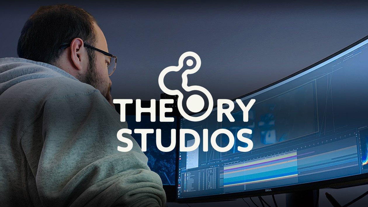 Theory Studios logo over man looking at computer monitor