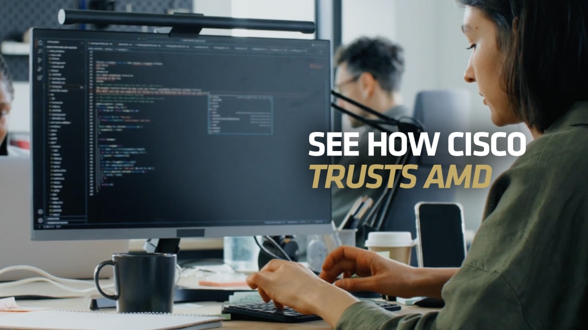 Developer coding at desktop monitor in office with text “See How Cisco Trusts AMD”