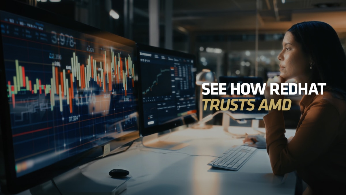 Person at desk viewing financial charts on multiple monitors; text reads “SEE HOW REDHAT TRUSTS AMD”
