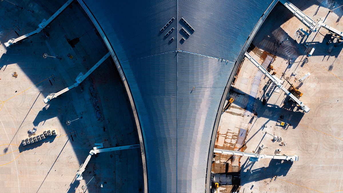 Aerial View of Airport Terminal Roof Construction with Service Equipment