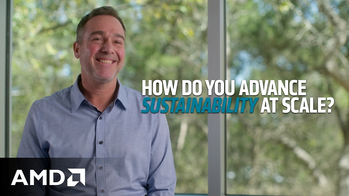 Smiling man in office interview with text reading “How do you advance sustainability at scale?” and AMD logo.