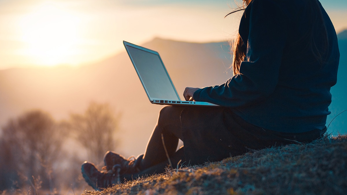 Woman working in nature on laptop