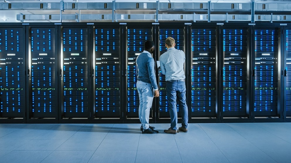 Two men working together in a datacenter Two men working together in a datacenter