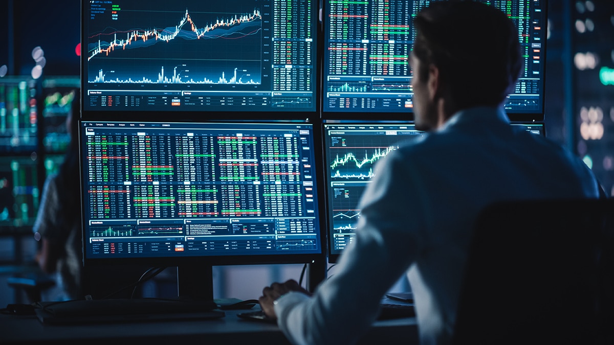 Man analyzing financial data on screens