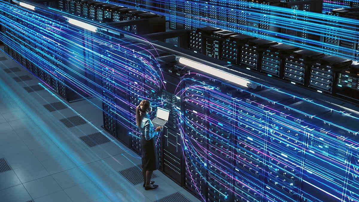3D Graphics Concept: Big Data Center Female Chief Technology Officer Using Laptop