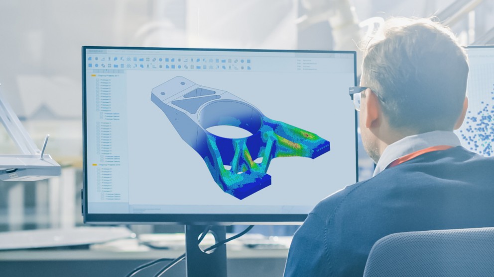 Man working at a computer on a 3D modeling program