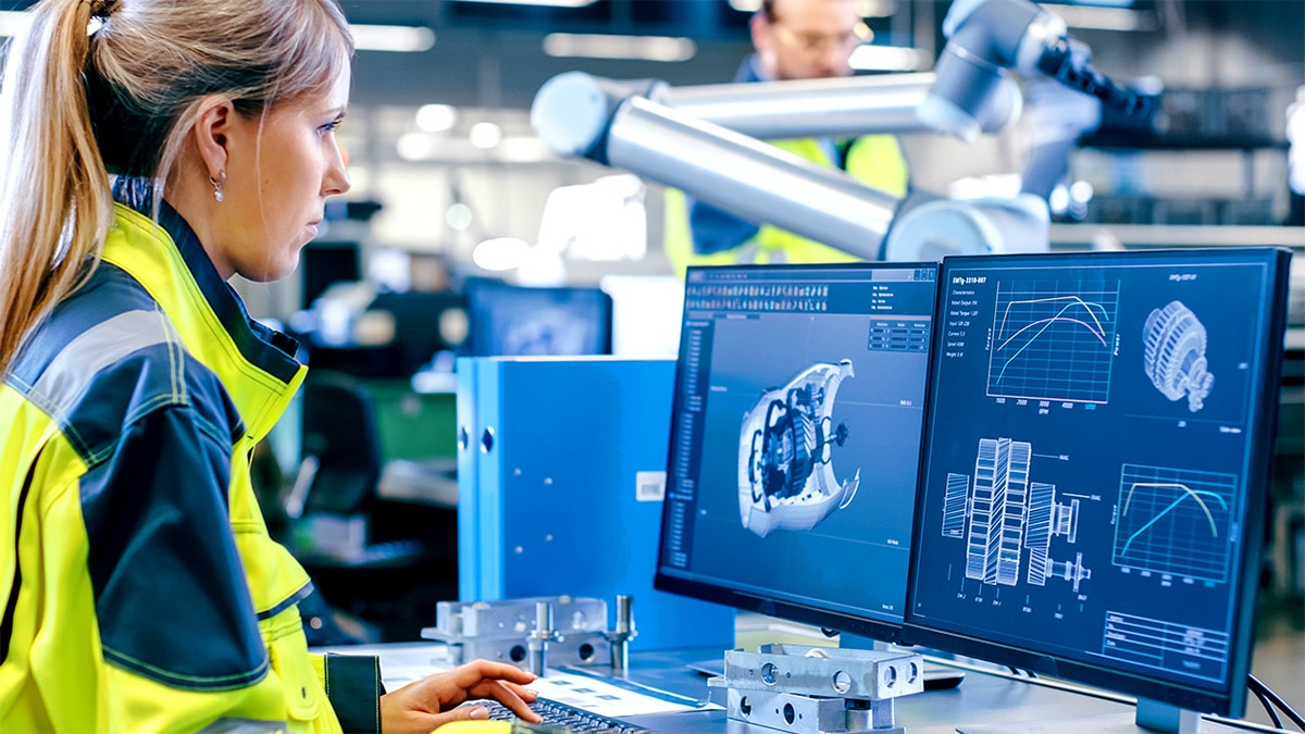Woman working on desktop computer in manufacturing