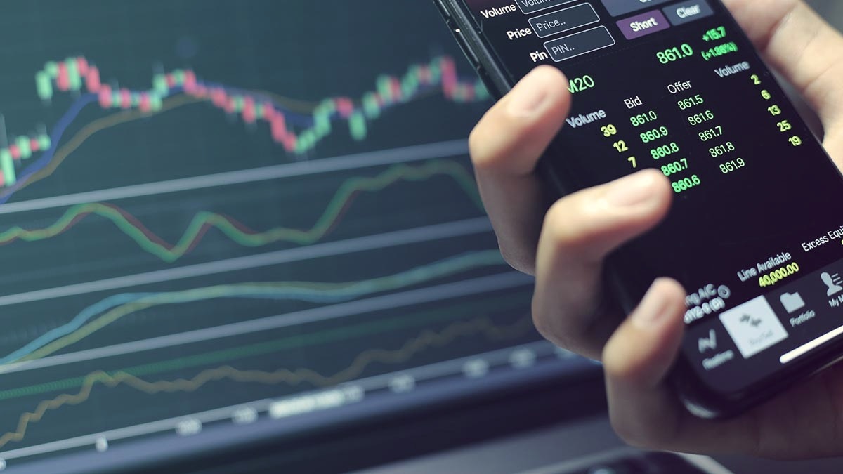 market data on computer screen and phone