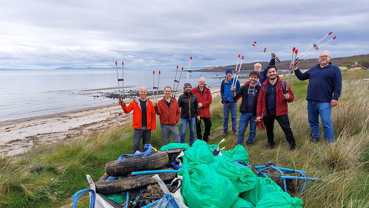 AMD Volunteers doing cleanup on a beach for Earth Day