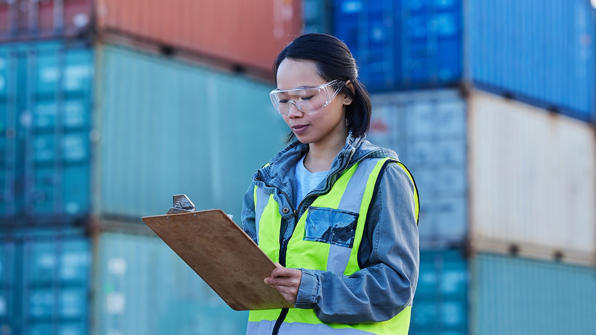 Asian woman checking container boxes