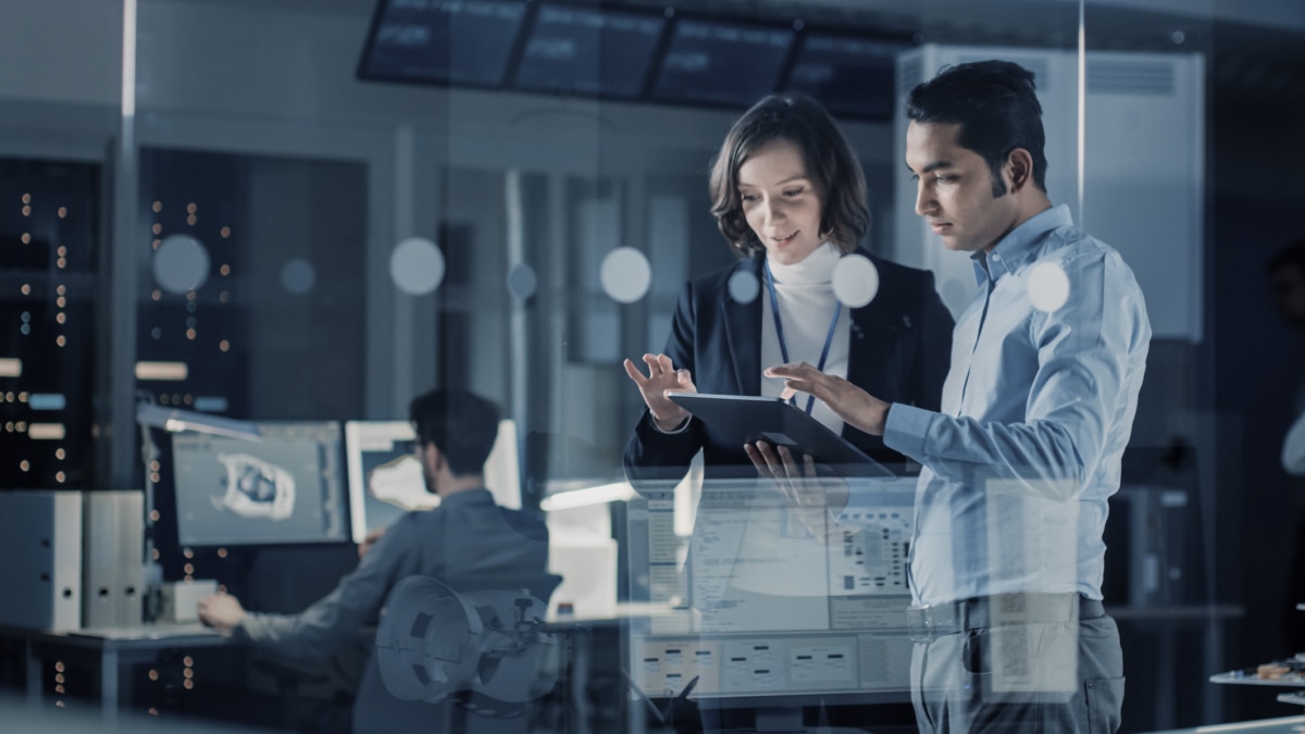 two people working in a data center. 