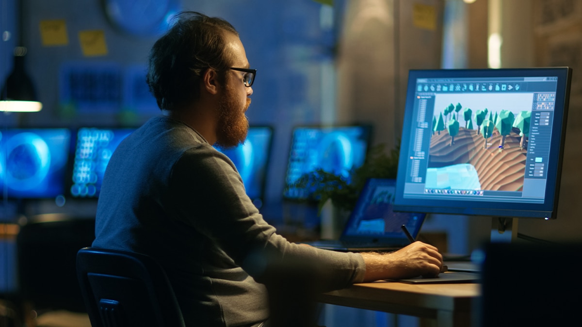 man creating images on computer screen man creating images on computer screen
