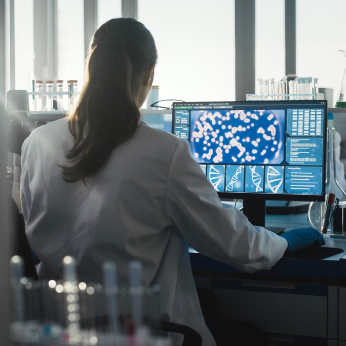 Scientist working on a computer in a lab