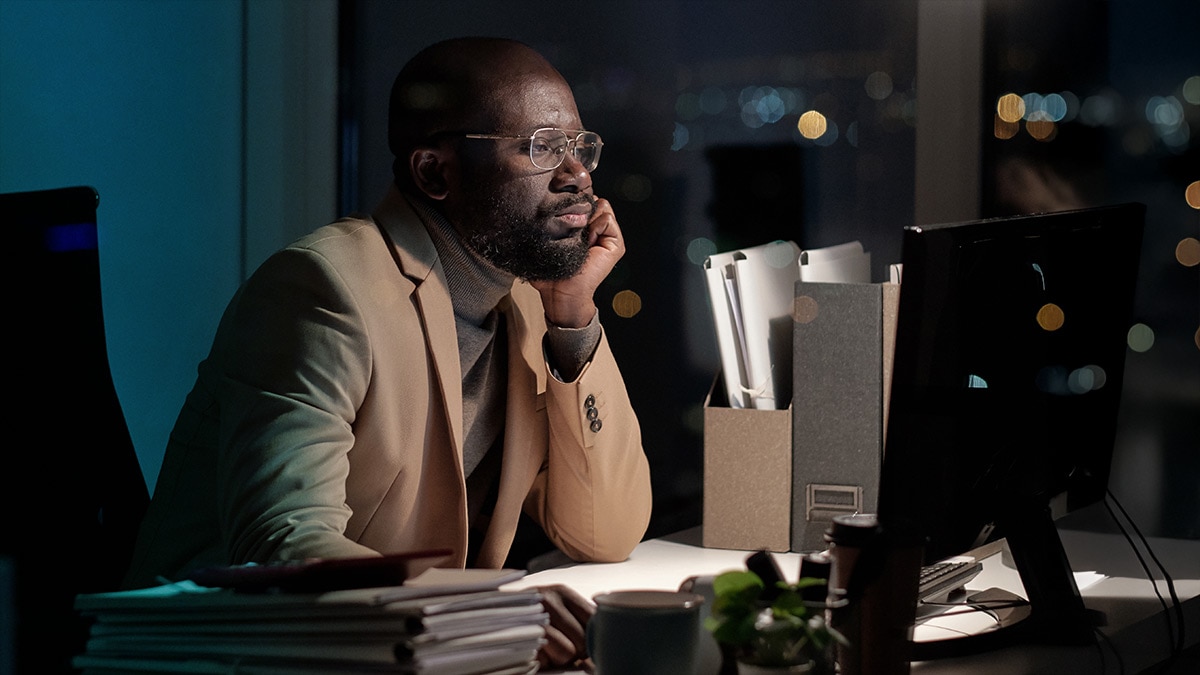 African businessman working in front of computer monitor