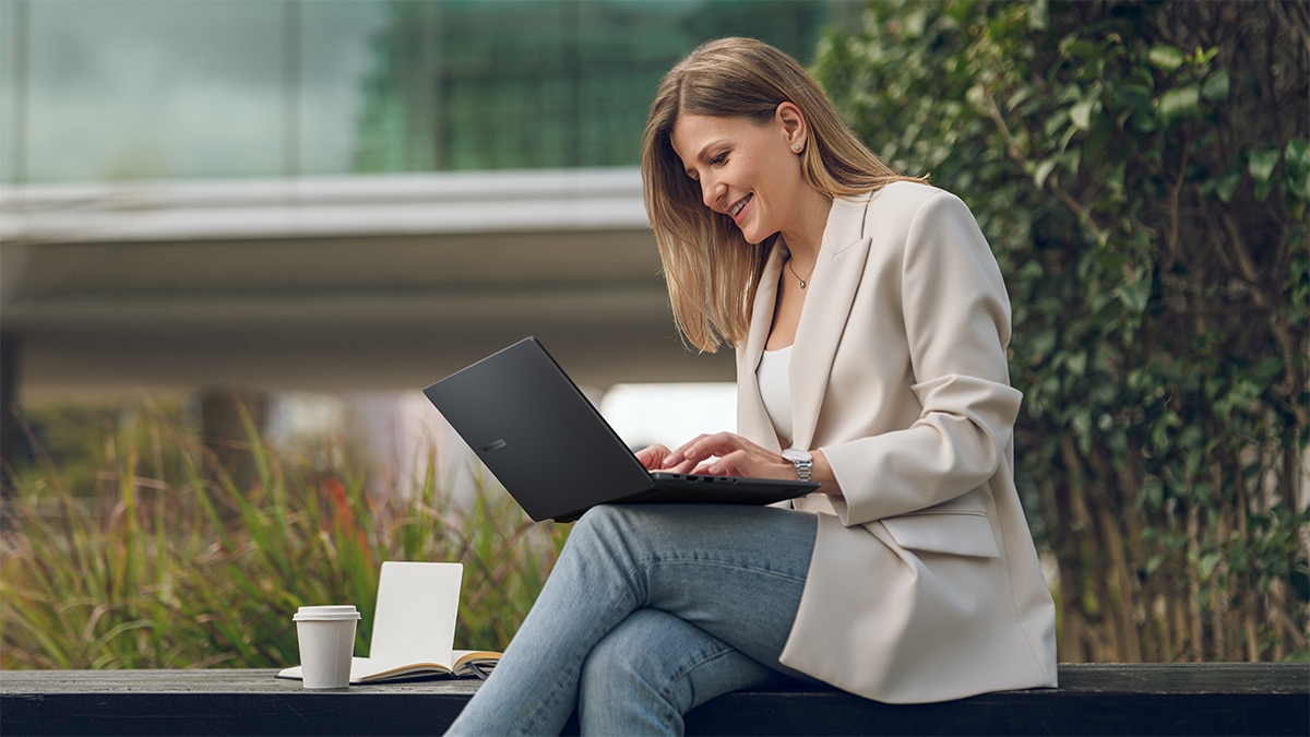 Woman working on a laptop outside Woman working on a laptop outside