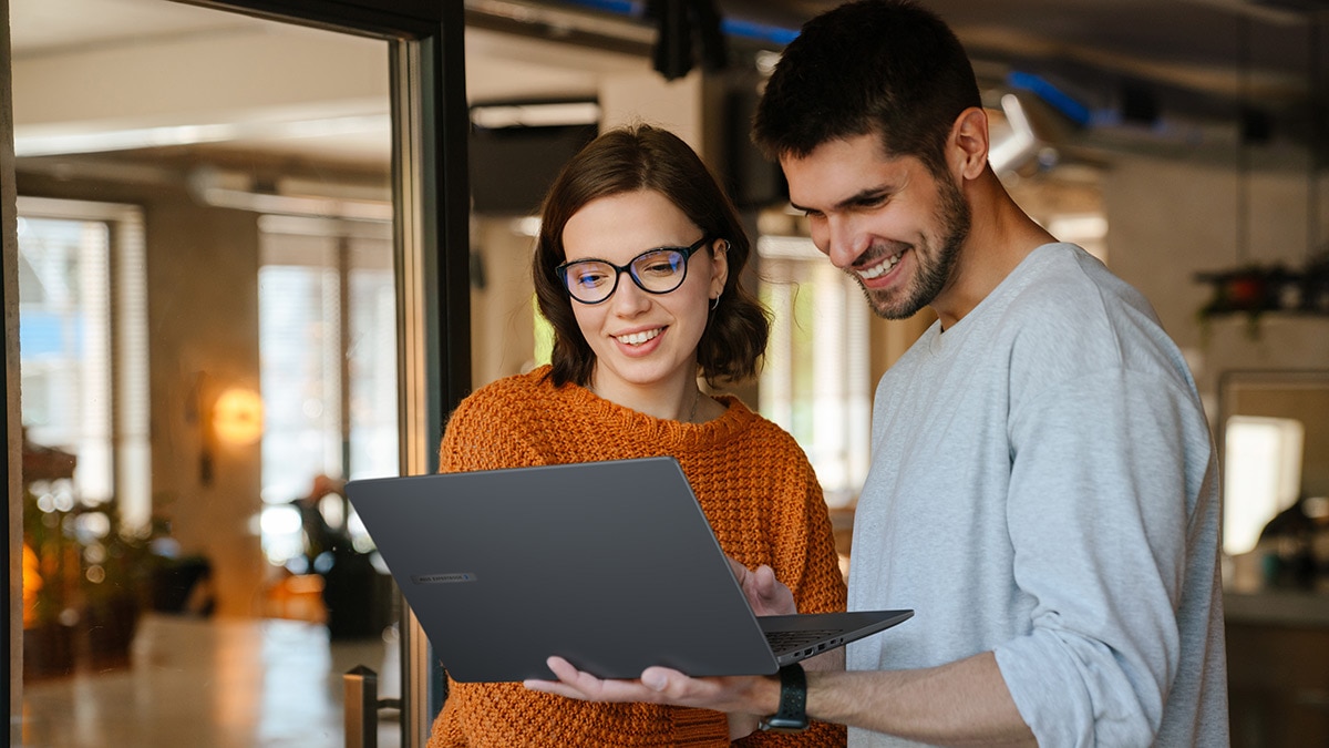Man and woman working on a laptop together Man and woman working on a laptop together