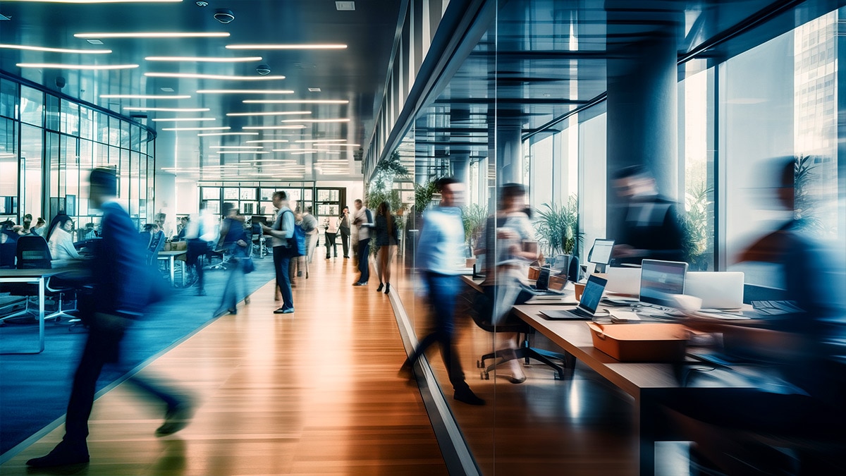 Bright business workplace with people in walking in blurred motion
