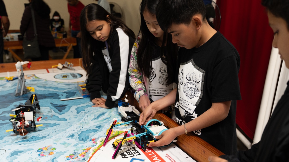 Kids working on a robot at the classroom