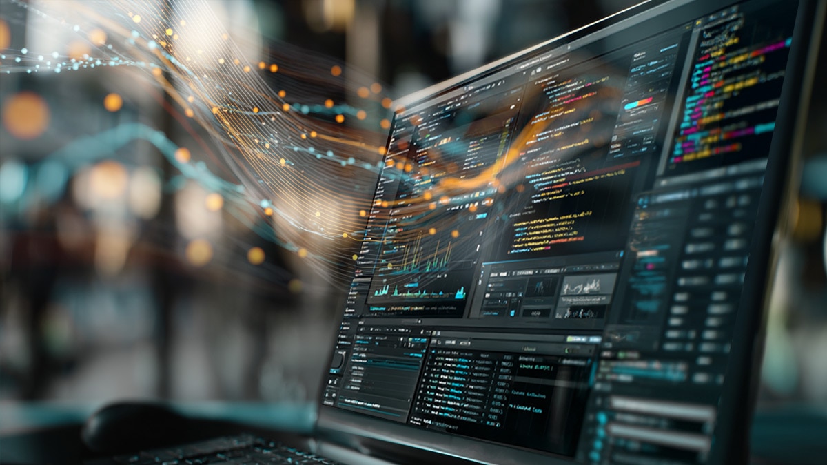 Laptop on wooden desk displaying code editor