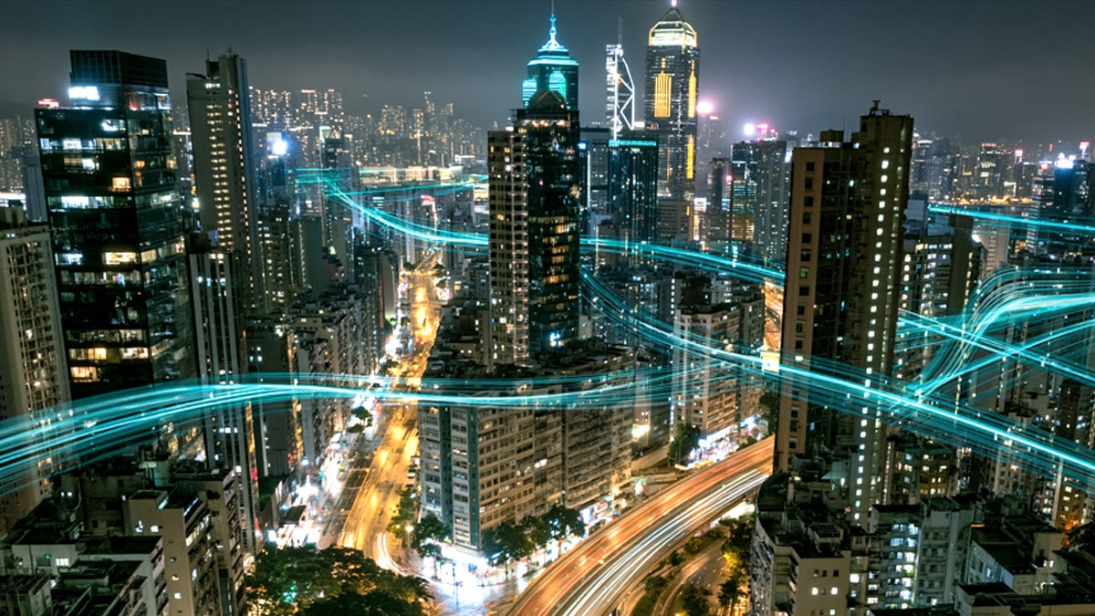 Futuristic telecom network infrastructure integrated with city skyline at night
