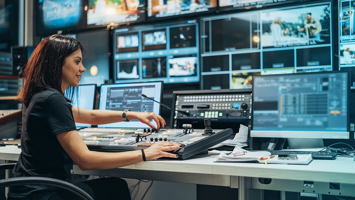 Woman working in a broadcast control room on a tv station