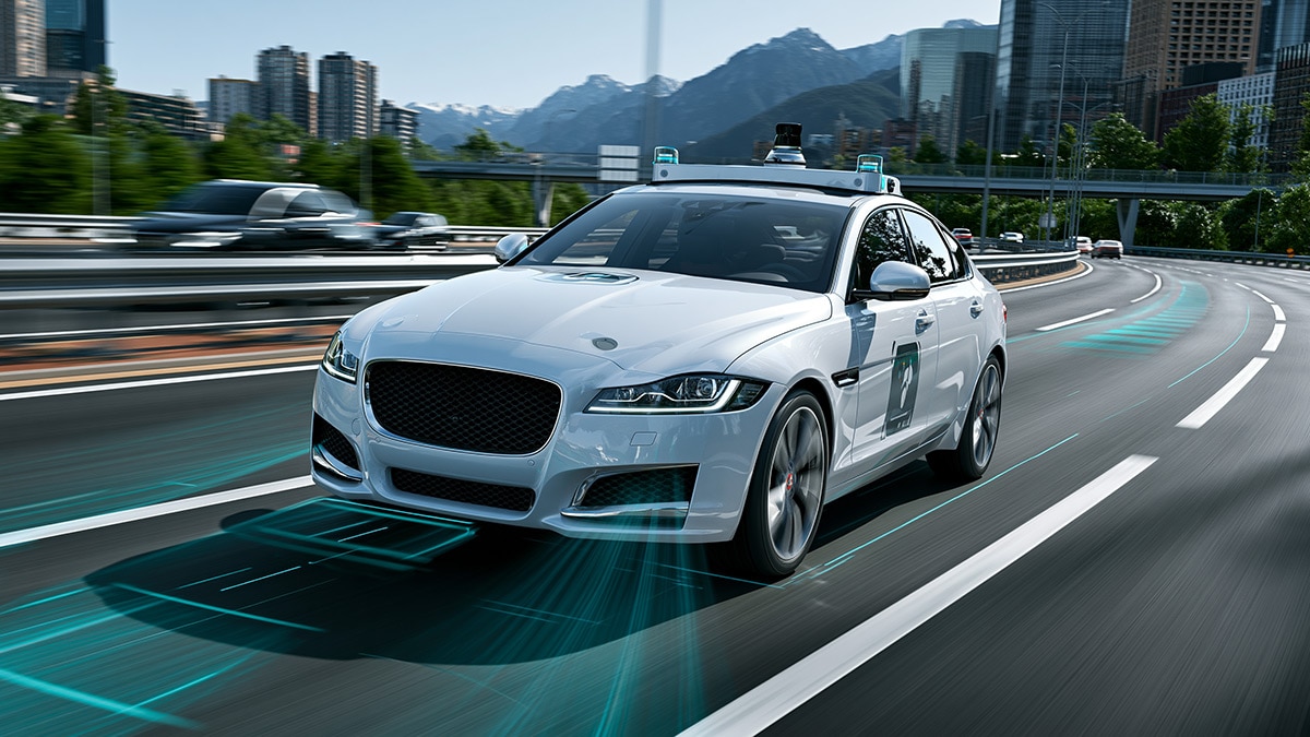 Self-driving sedan cruising on a multi-lane highway