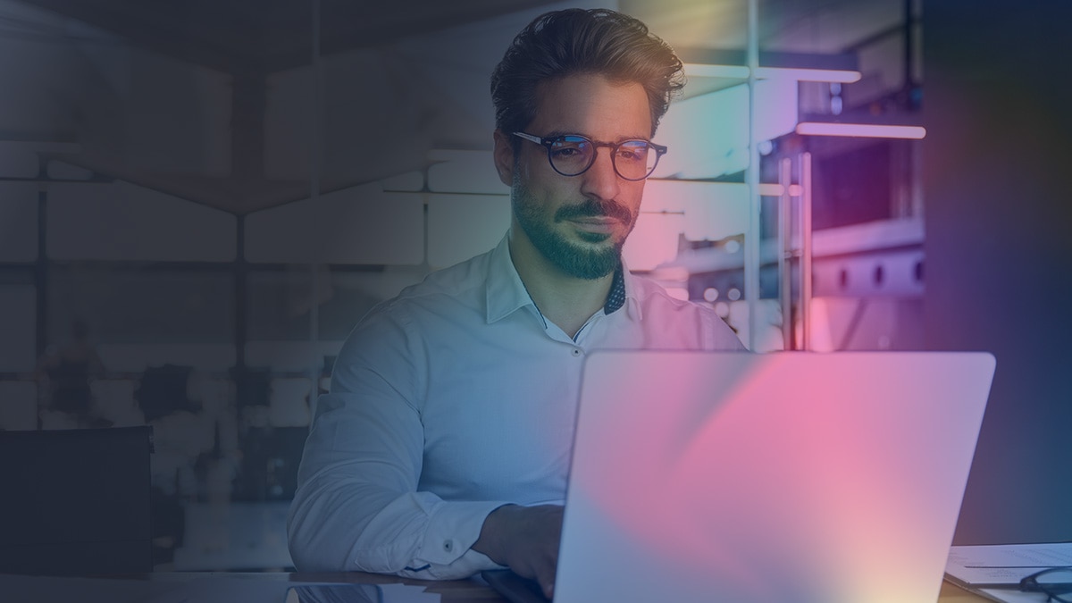 Man working on laptop at his office's breakout space