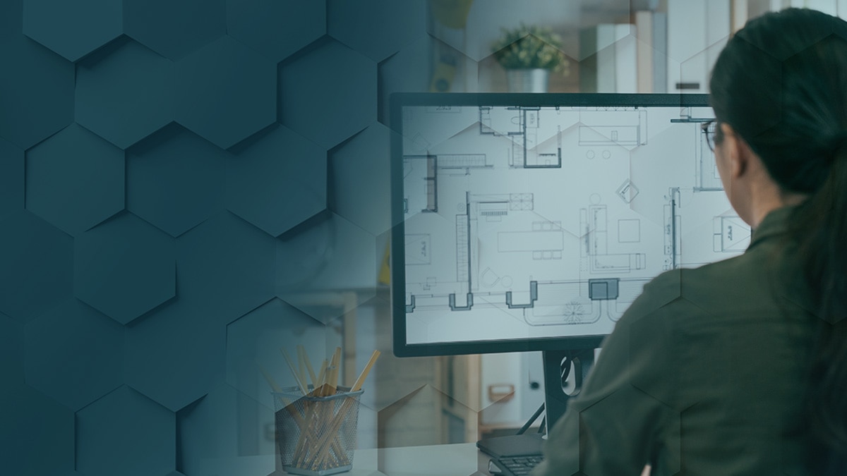 Woman working in architecture creating a plan for the house on desktop computer